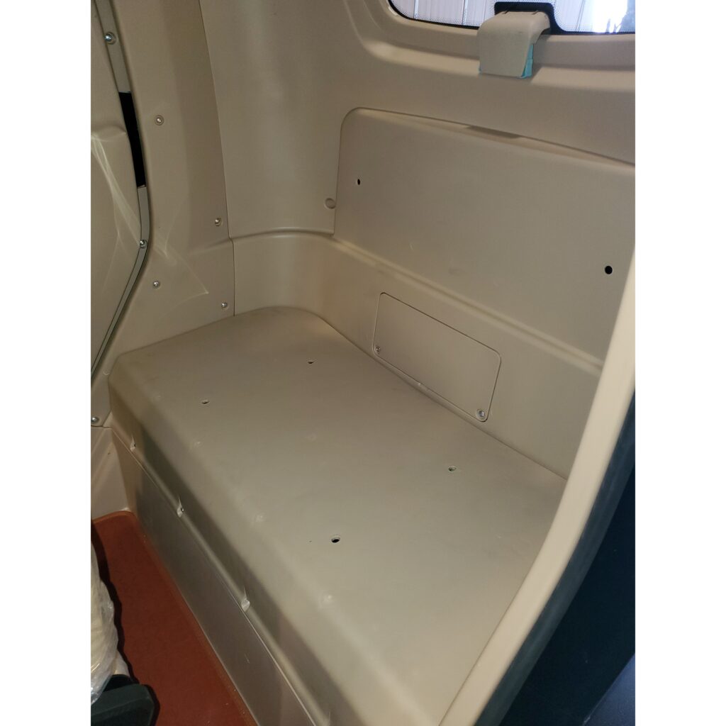 Interior of a GIO Golf enclosed mobility scooter showing a plain beige bench seat at the back.