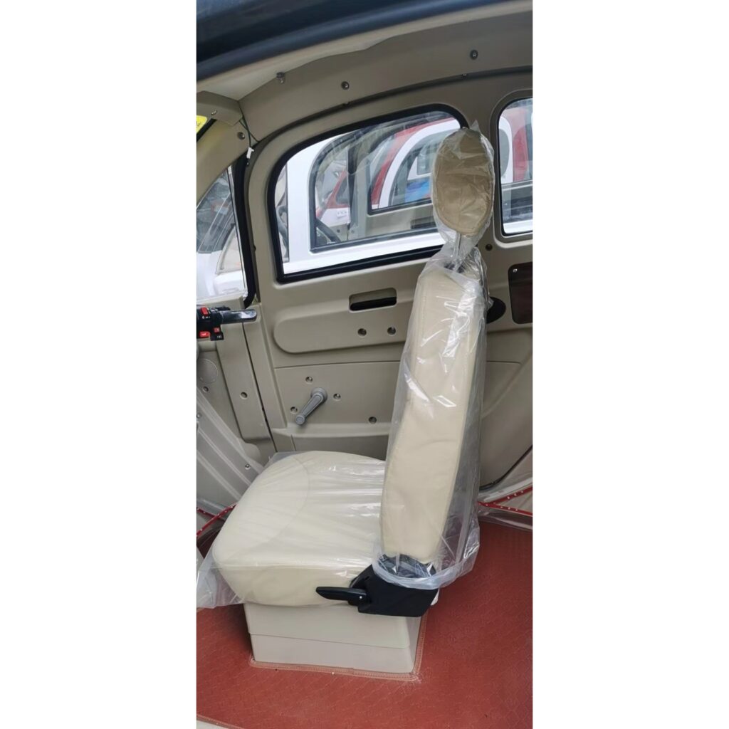 Interior side view of a GIO Golf mobility scooter, showing a wrapped driver's seat in beige.