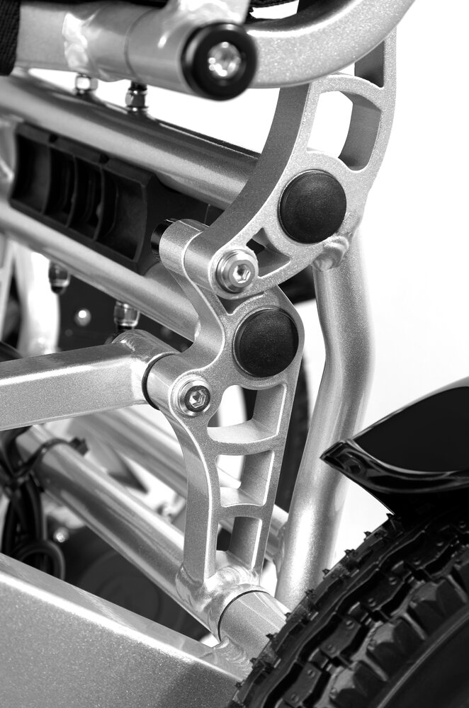 Porto Mobility Ranger Discovery XL folding power wheelchair, folding frame joint close up in black and white