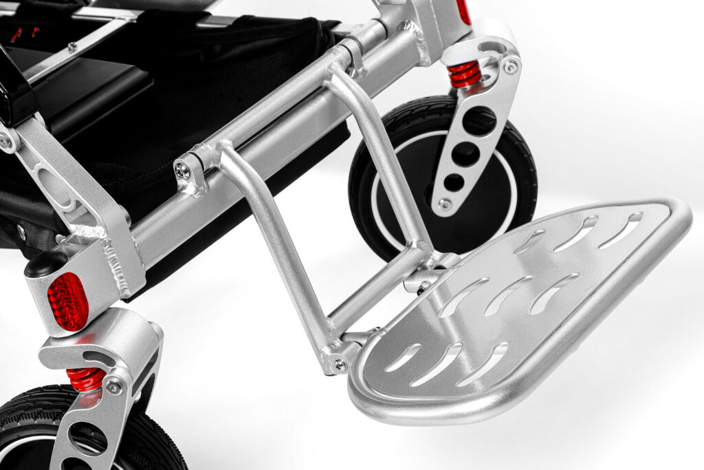 Porto Mobility Ranger Maestro XL reclining folding power wheelchair, silver slotted footplate close up