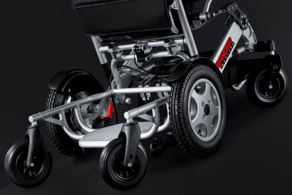 Porto Mobility Ranger Quattro XL folding power wheelchair, lower frame, footplate and front casters, low angle