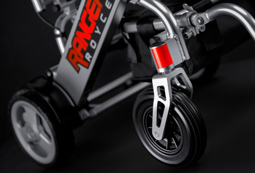Porto Mobility Ranger Royce folding power wheelchair, front caster and frame logo close up